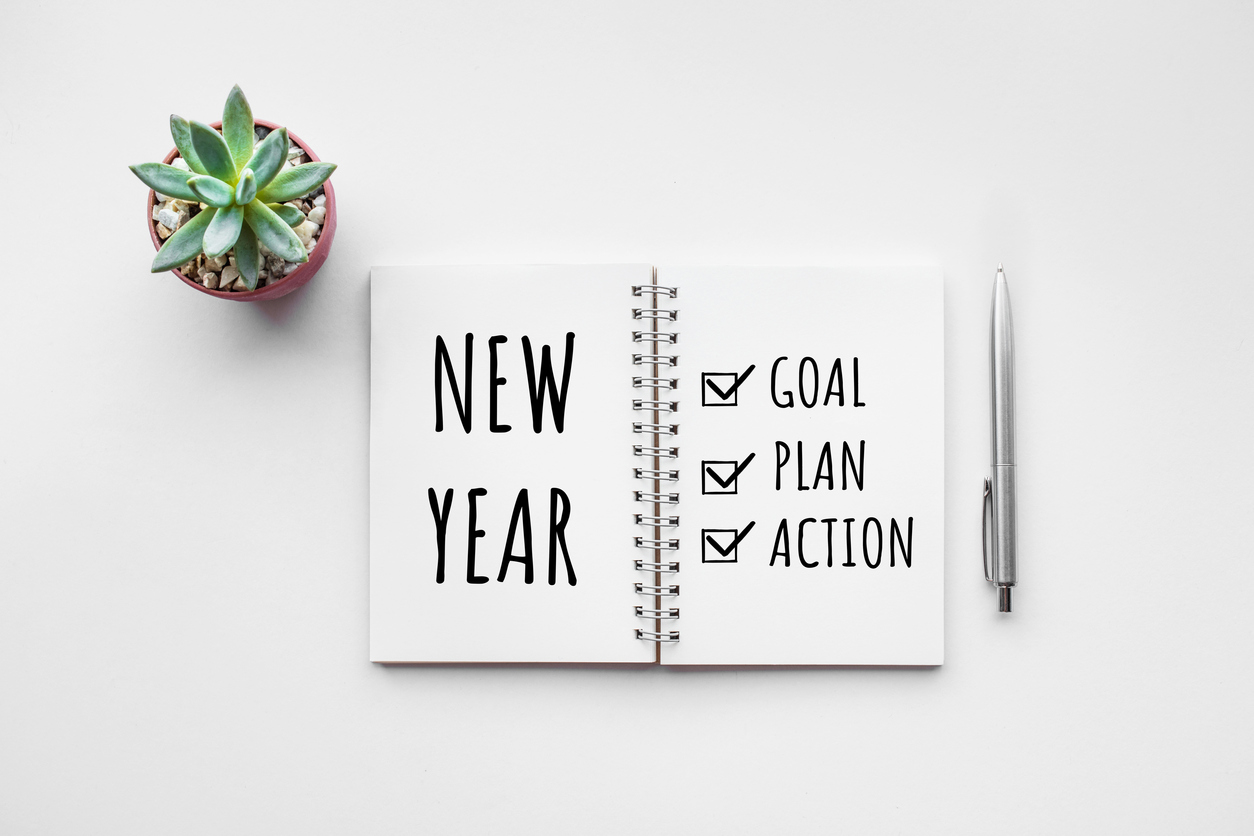 New year goal,plan,action text on notepad with office accessories. Goal Setting
