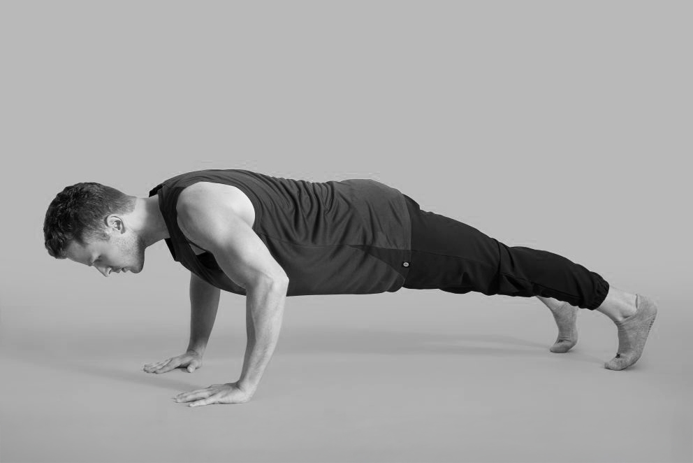 A man is holding a push-up position.