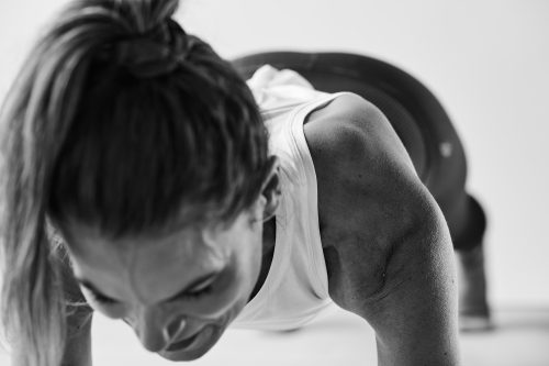 Woman holding a plank exercise during a Bar Method class.