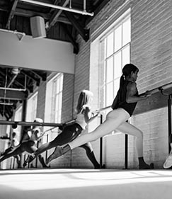 Women participating in a barre workout at The Bar Method.