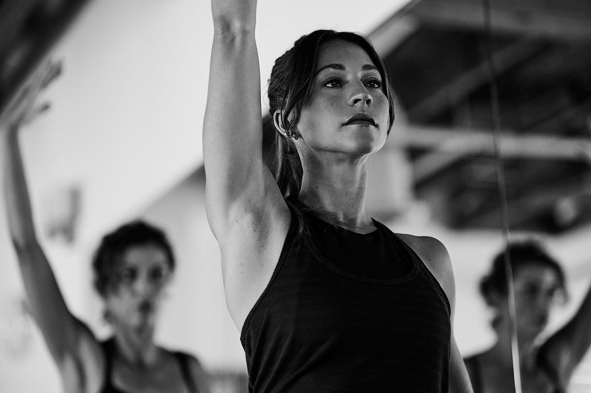 Black and white image of woman smiling in a Bar Method Studio