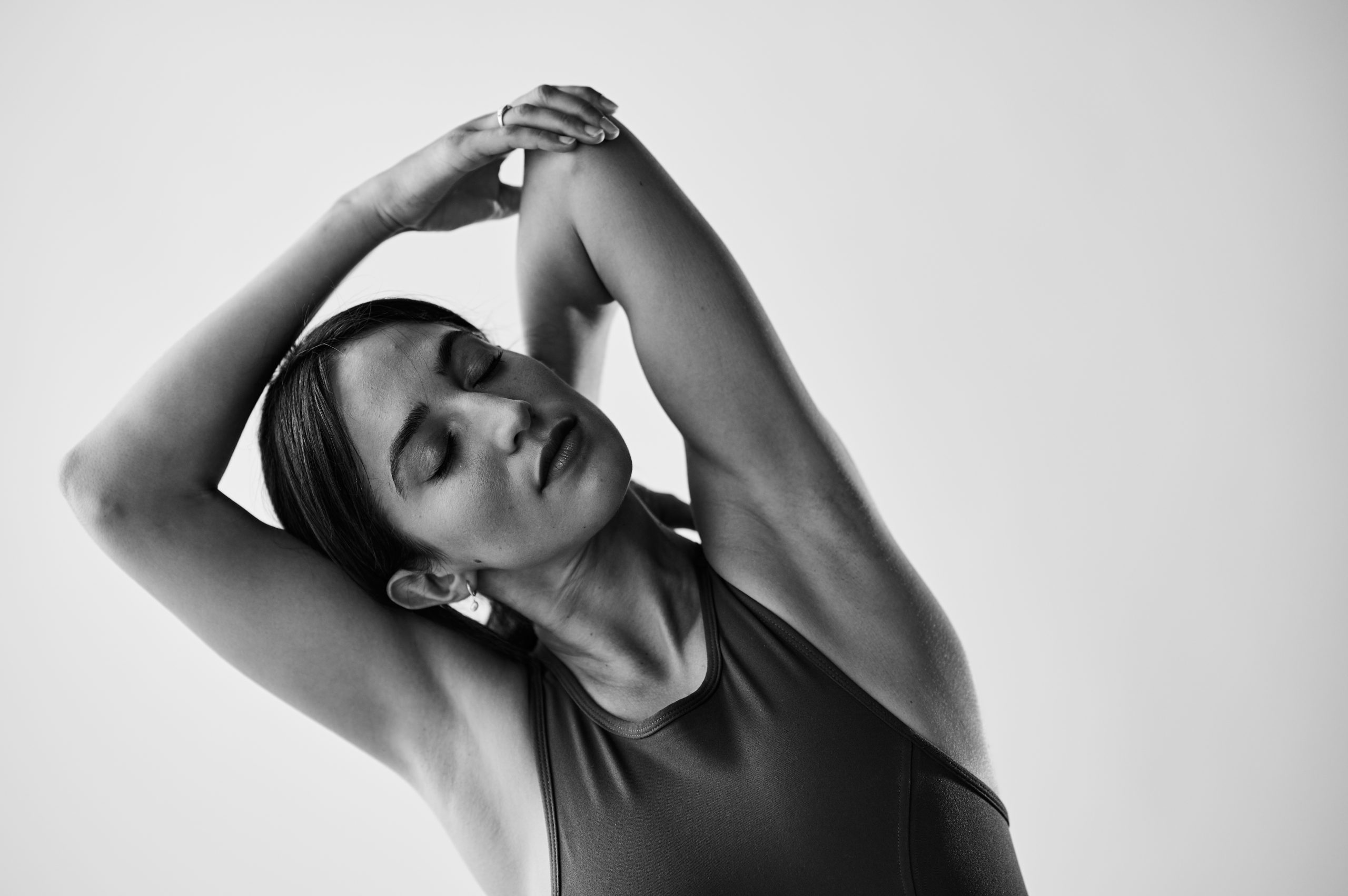Black and white image of woman smiling in a Bar Method Studio