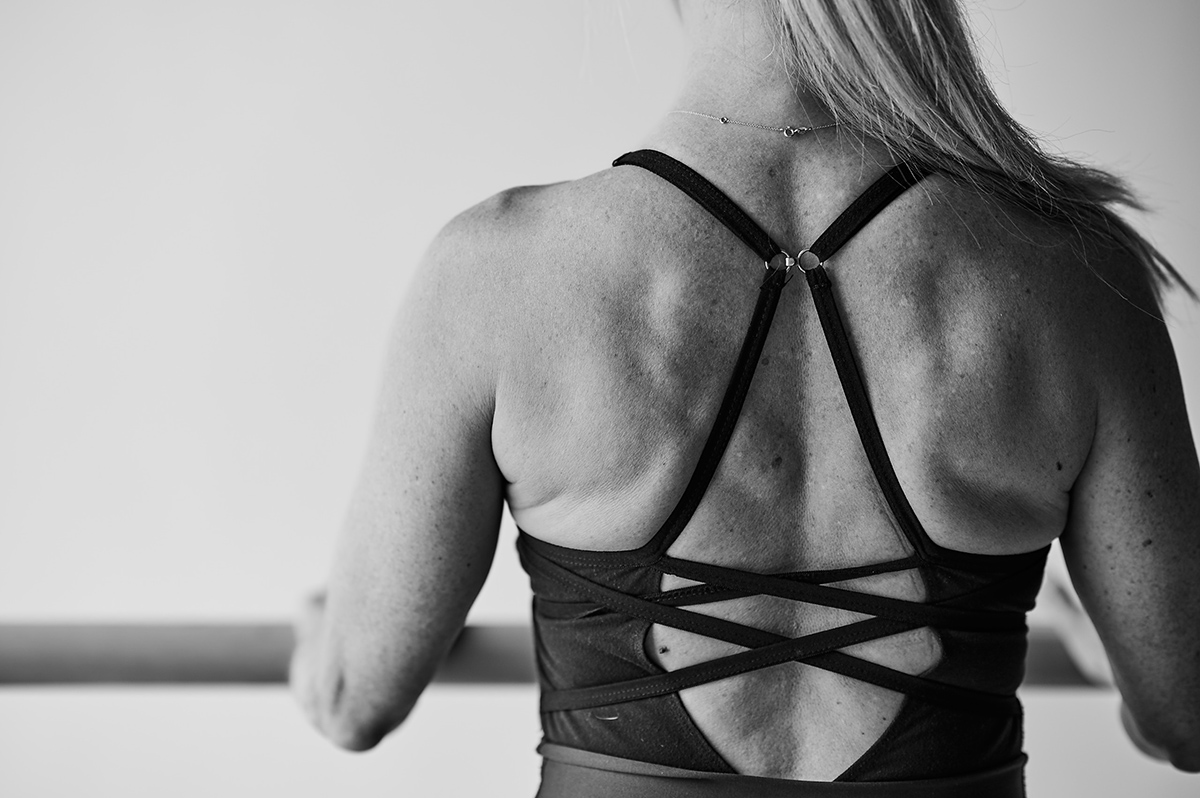  Black and white image of woman smiling in a Bar Method Studio