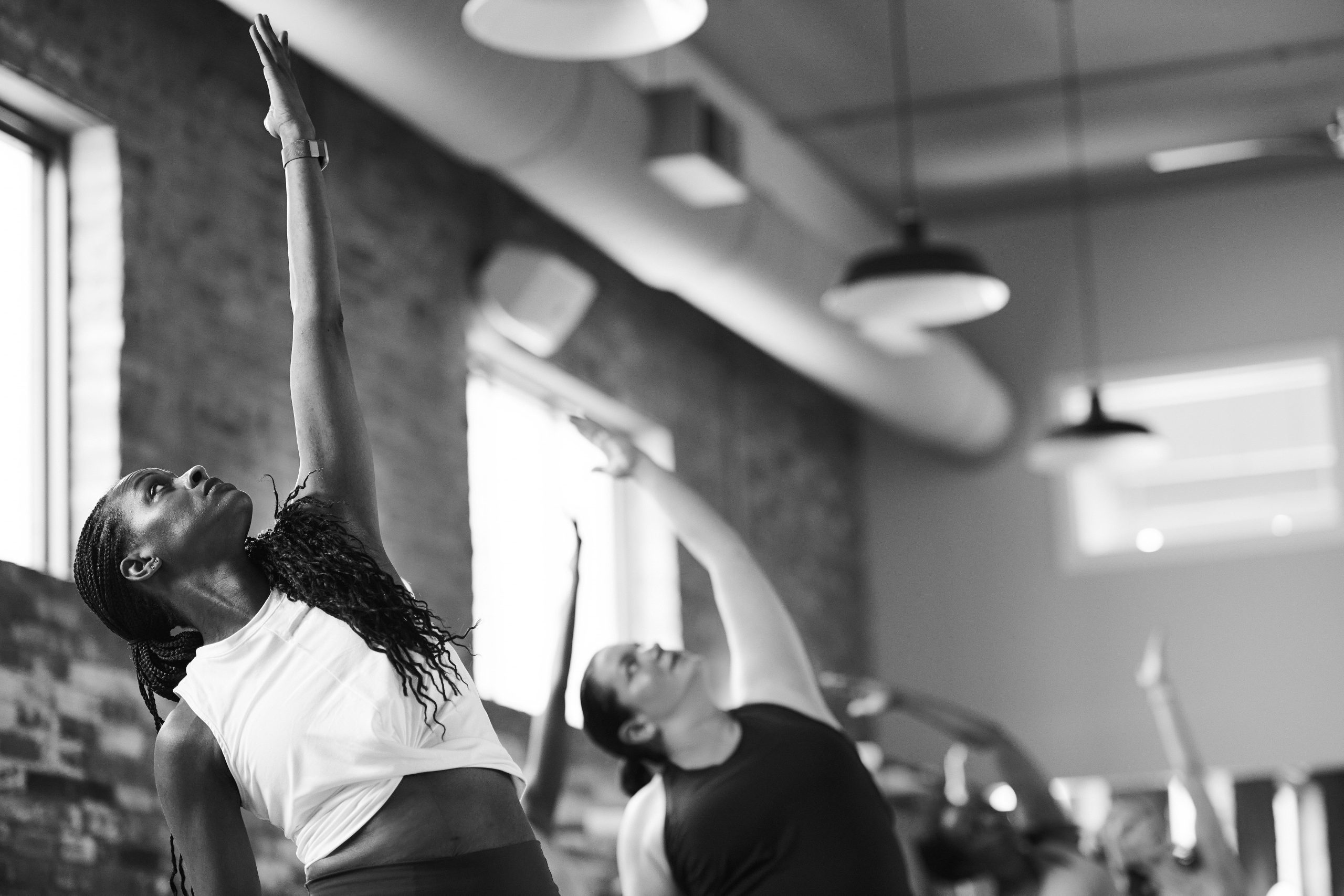 Black and white image of woman smiling in a Bar Method Studio