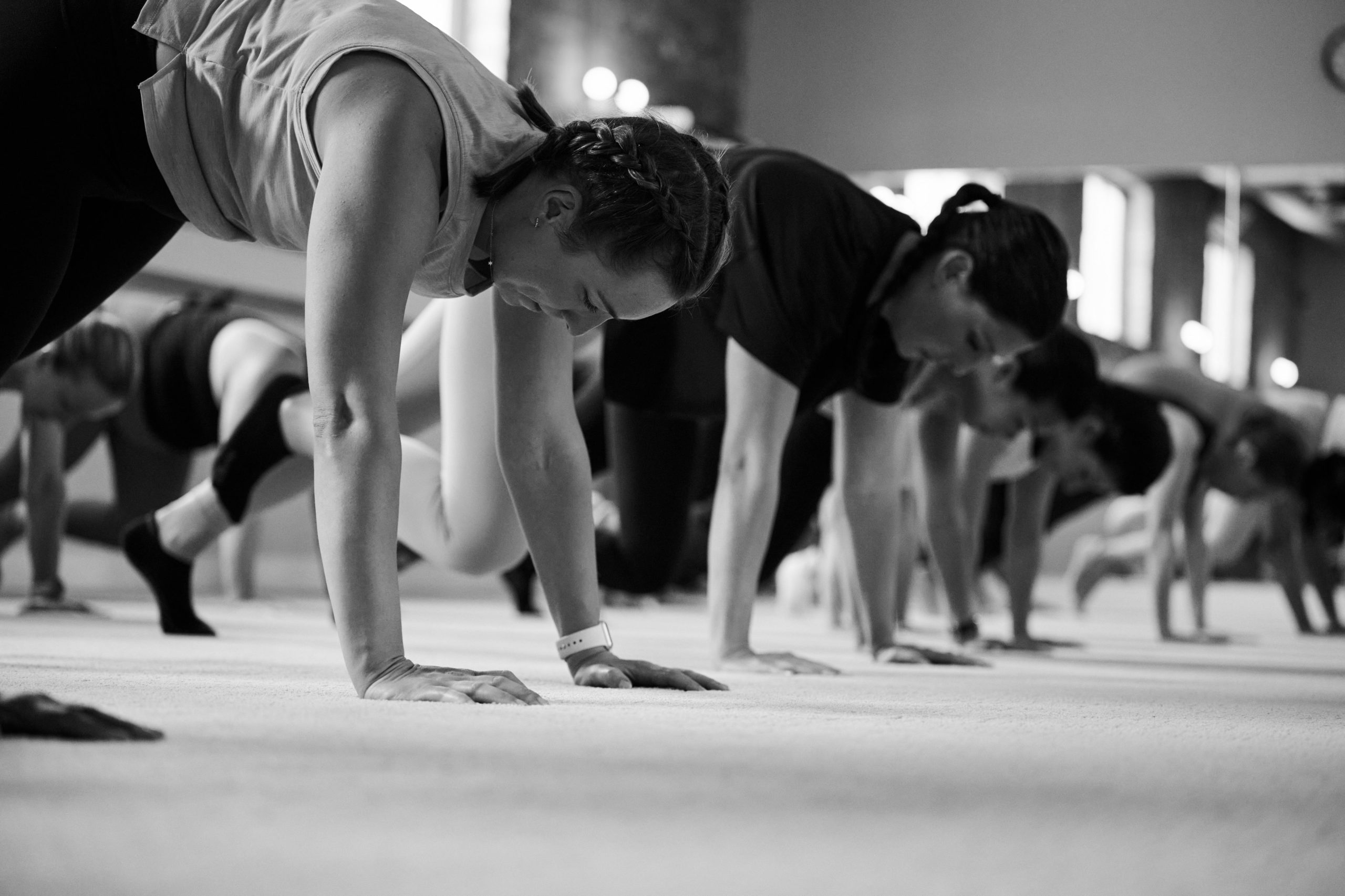 Woman working out with weights at the barre in Bar Method Studio
