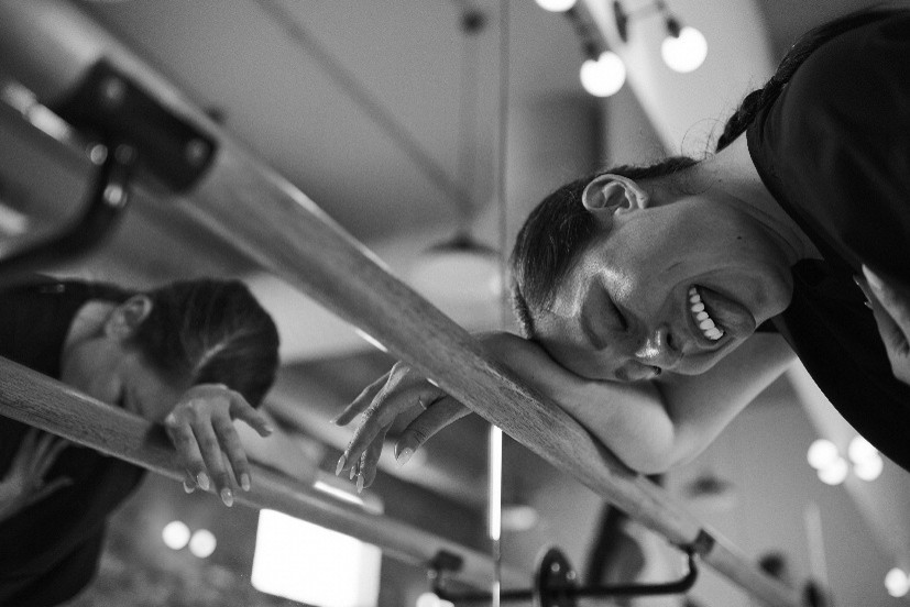 Client resting forehead on a barre after a Bar Method class