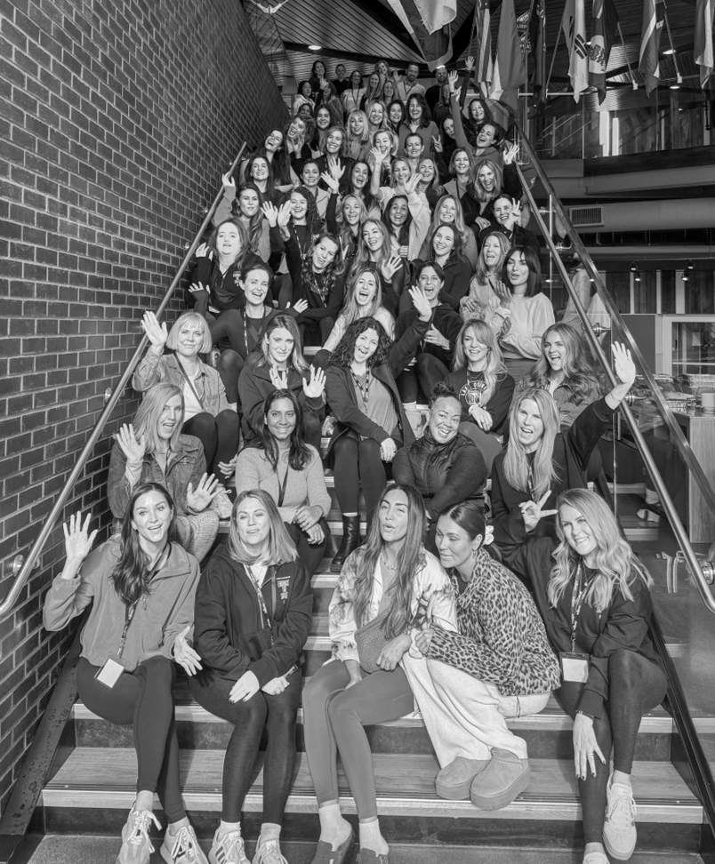 Bar Method owners sitting on stairs for a photo