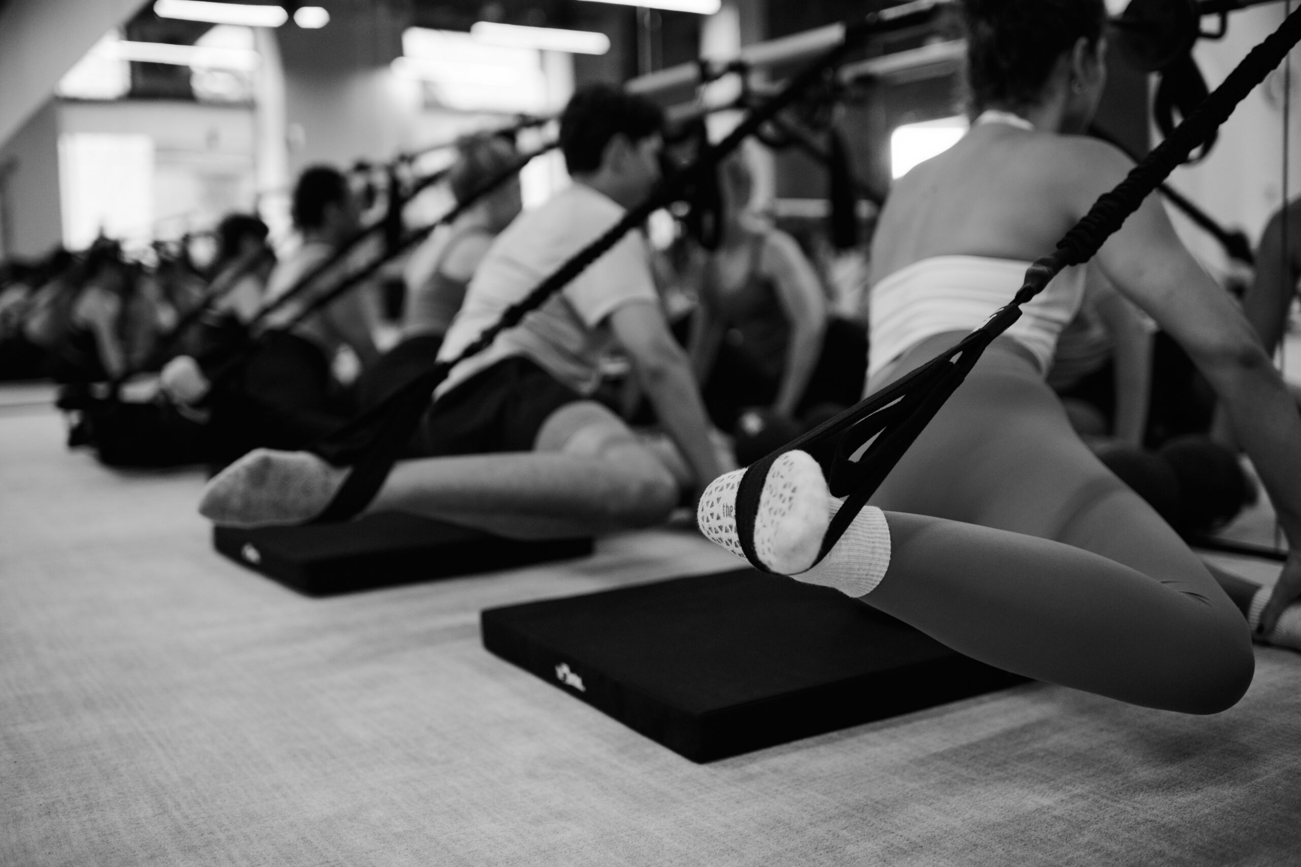 Woman working out with weights at the barre in Bar Method Studio