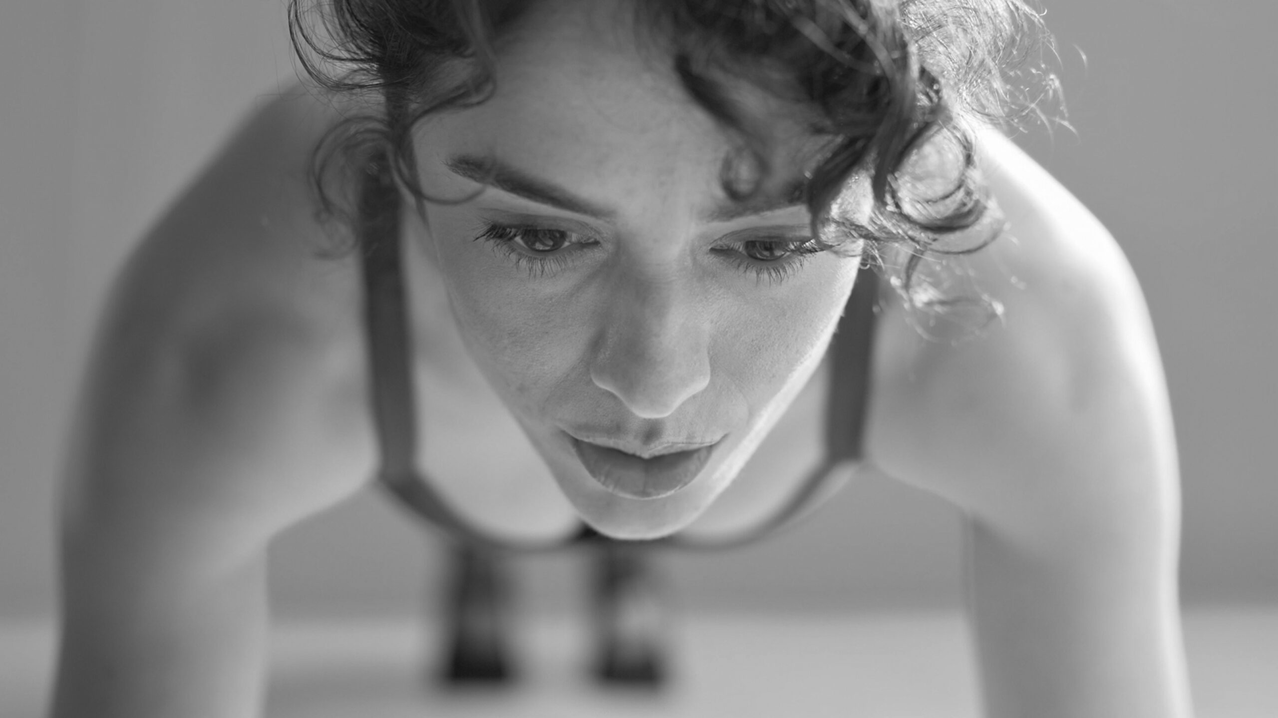 Bar Method instructor demonstrating a plank, part of a barre back workout.